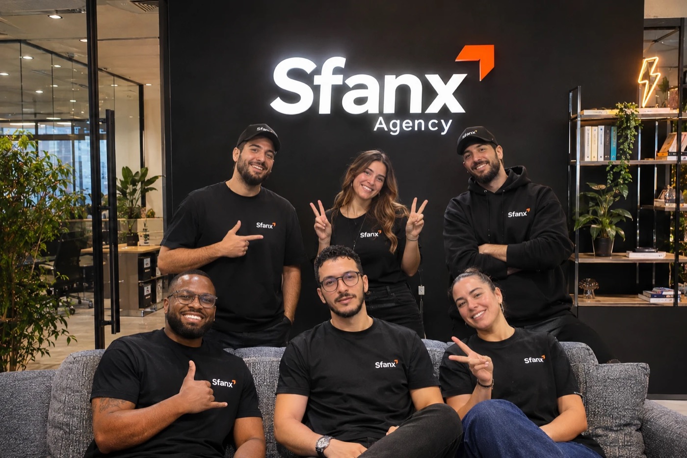 The Sfanx team in front of the Sfanx Agency sign